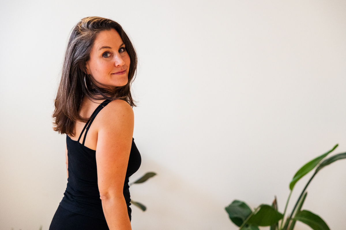 Jennifer Lacher in a black top looking back over her shoulder