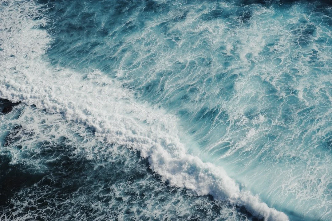 Turquoise ocean waves breaking along the shore