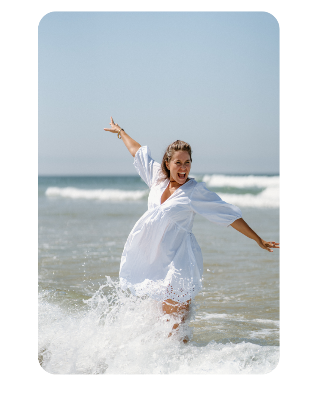 Woman laughing in the ocean waves